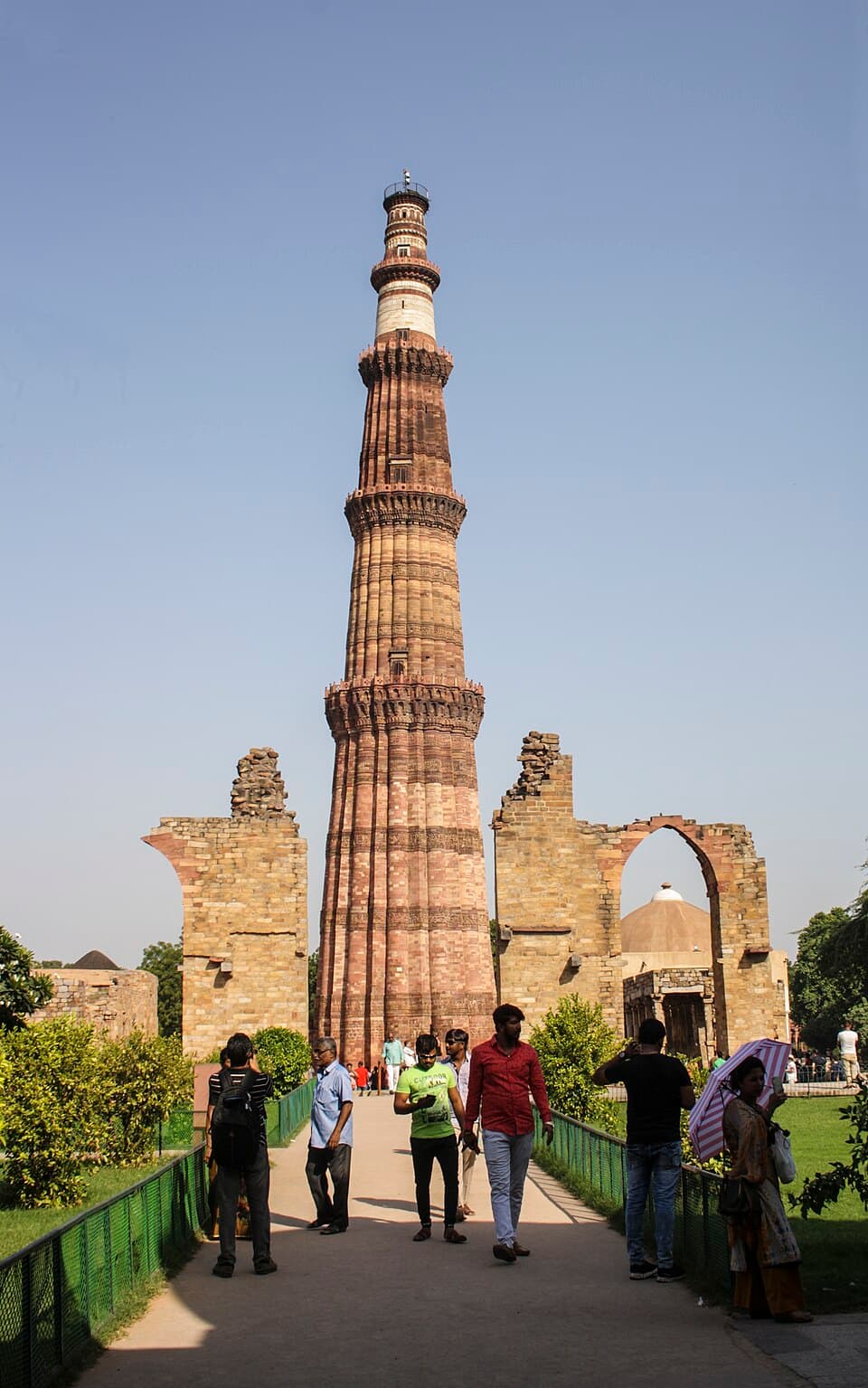 The Qutb Minar: The Qutb Minar at Delhi among the ruined arches of the Quwwat ul Islam mosque.